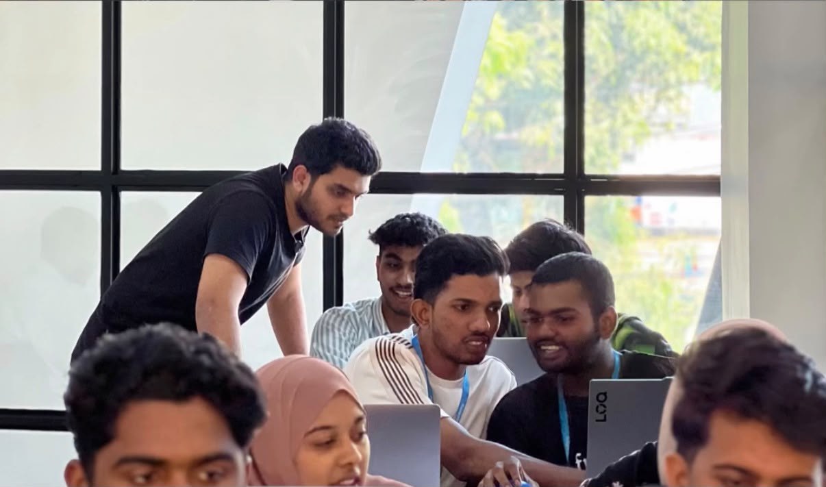 Trainer mentoring students on a lab project